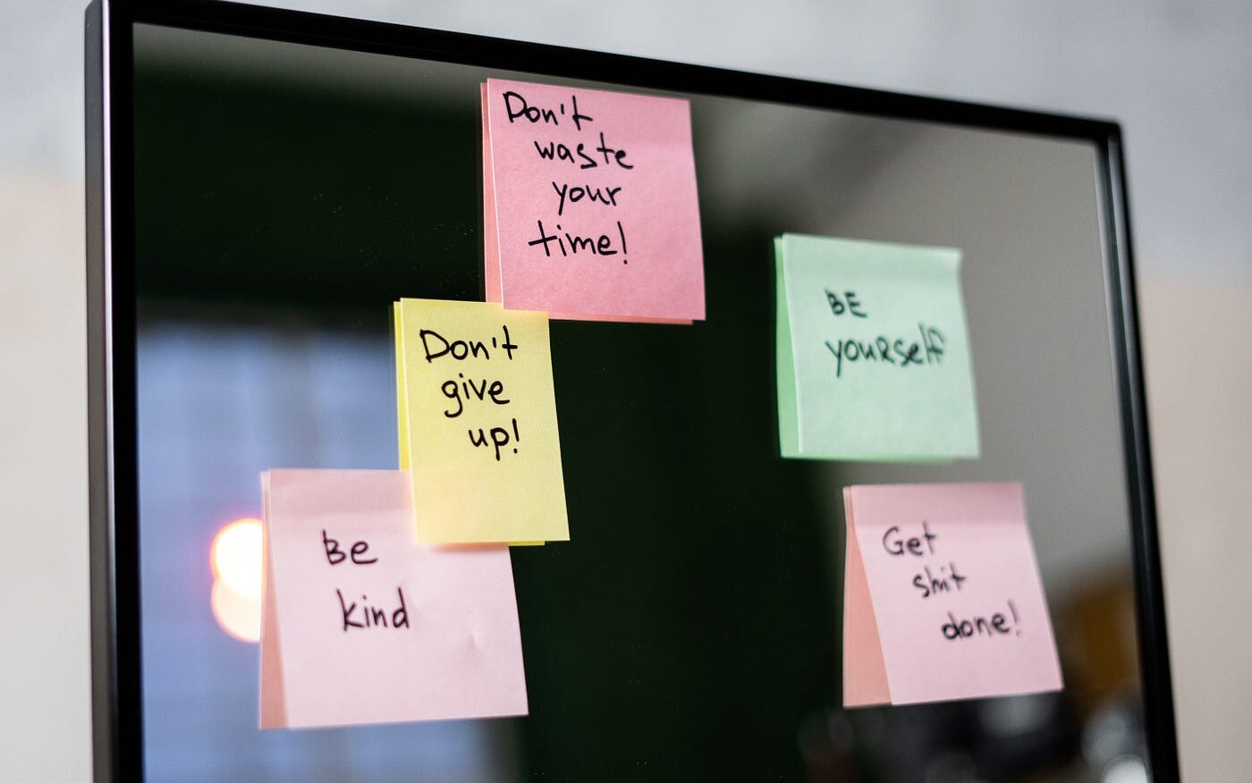 multiple sticky notes with different inspirational quotes on a black screen