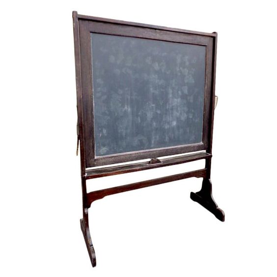 A wooden chalkboard on a white background. The chalkboard is standing upright on a wooden stand, and it has a chalk holder on the bottom shelf.