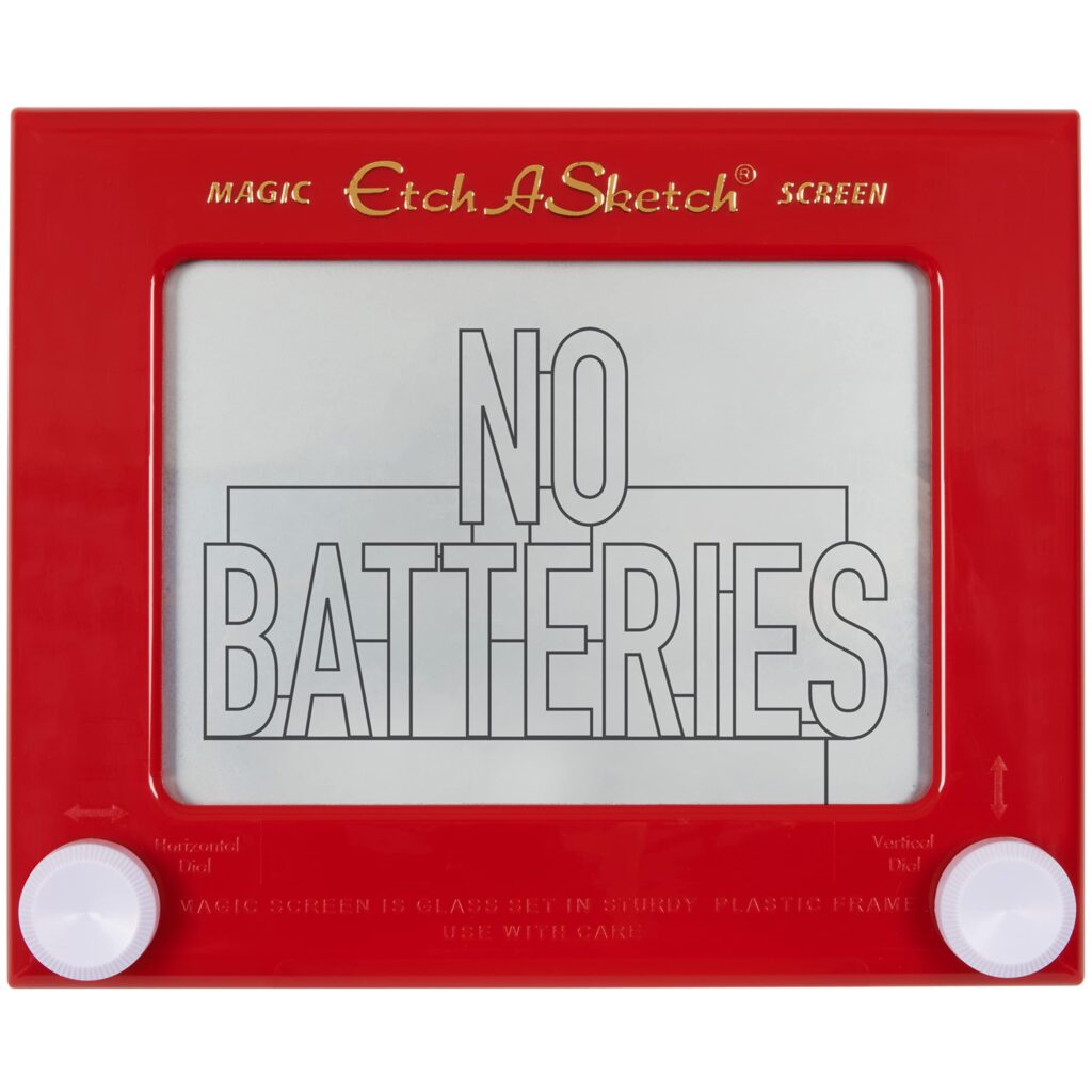 An etch a sketch with the words "no batteries" written on it. The words are all uppercase and the word no is above the word batteries
