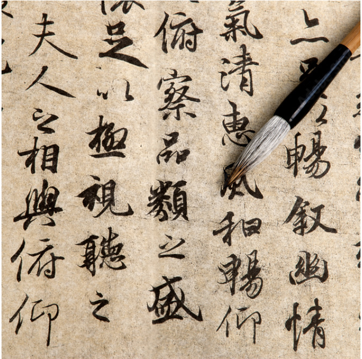 A decorative image used that shows a paper with some Chinese words written with ink.