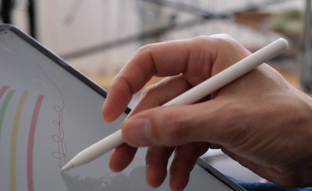 a person drawing random things on an Ipad with apple pencil.