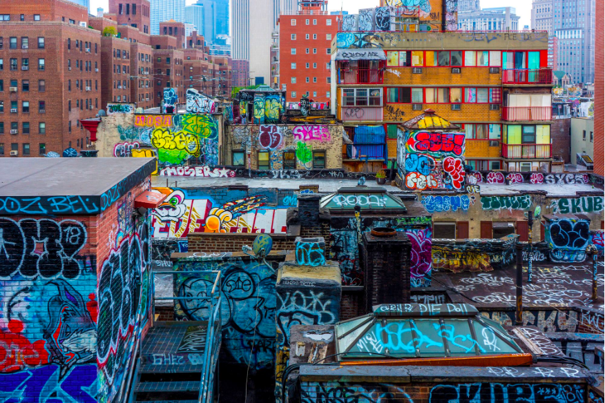 An image of a landscape with lots of colorful graffiti on buildings. 