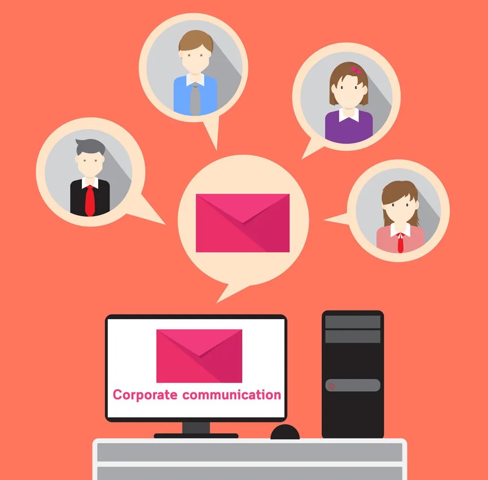 An image of businesspeople in a corporate setting communicating through email
