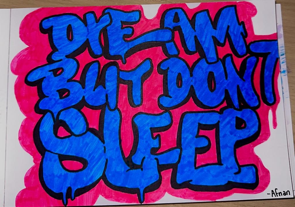 A colorful drawing with the words "dream but don't sleep" written on it colored pink and blue.