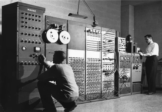 Technicians operating an early mainframe computer, a foundational technology for modern computing."